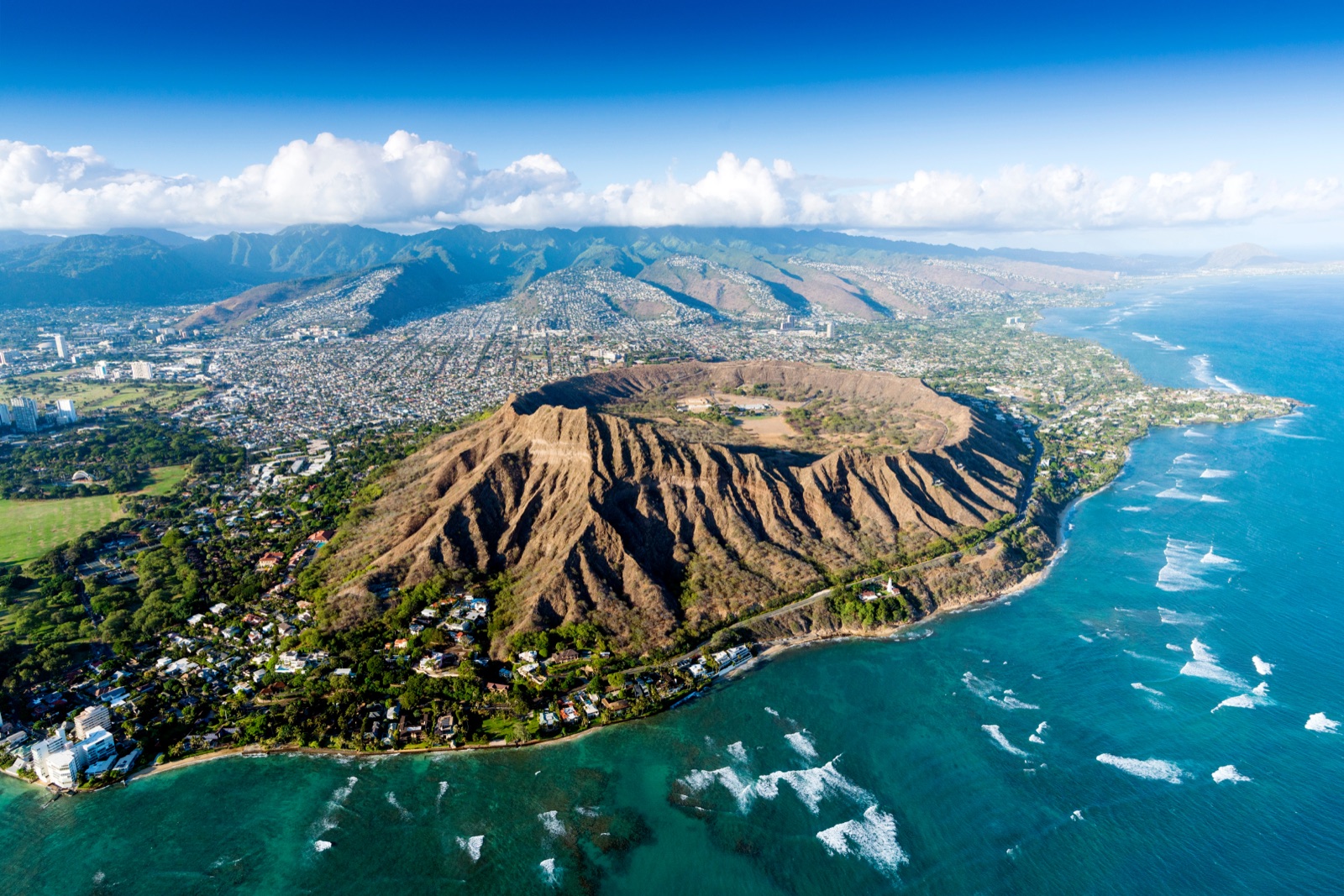 Aerial view of Diamond Head crater and the Honolulu coastline at golden hour